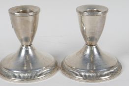 A pair of sterling silver dwarf candlesticks (loaded), 3¼" high