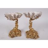A pair of antique French ormolu and shell table salts cast as dolphins on scrolled bases with