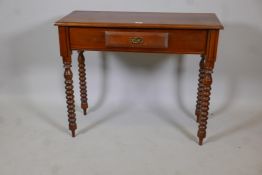 A hardwood single drawer side table, raised on bobbin turned supports, 36" x 16" x 30"