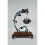 An Oriental hardwood and bronze incense burner of dragon and lotus flower form, 12" high