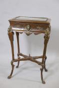 A C19th oak bijouterie table with Renaissance revival style brass mounts, and glazed lift up top,