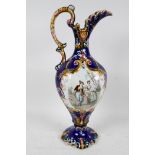 A Continental majolica pottery ewer decorated with a panel depicting a romantic couple, 15" high