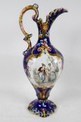 A Continental majolica pottery ewer decorated with a panel depicting a romantic couple, 15" high