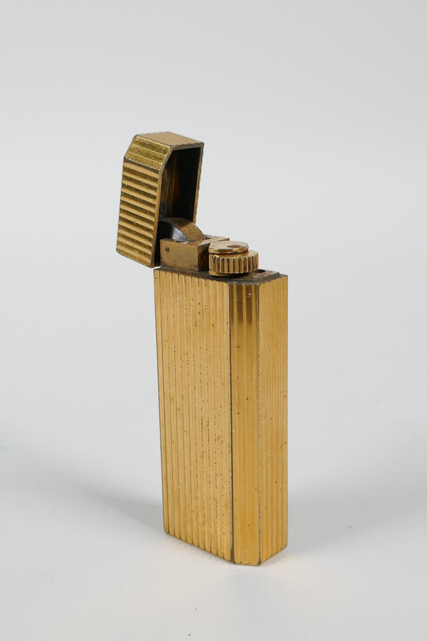 A gold plated Cartier lighter, 3" long - Image 2 of 3