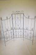 A three fold metal garden screen in the Gothic style, 71" high