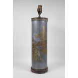 A pewter and brass cylinder lamp with Chinese decoration depicting figures and a buffalo, 21" high