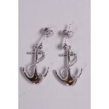 A pair of silver earrings in the form of anchors, 1" drop