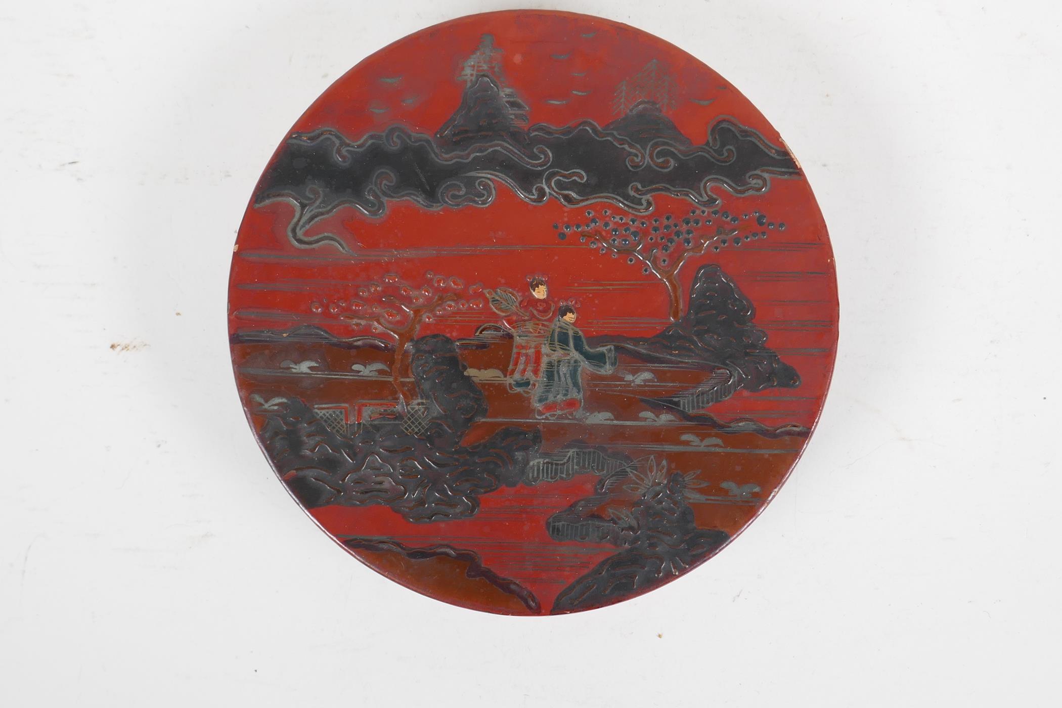 A Japanese red and black lacquer cylinder box decorated with figures in a landscape, the interior - Image 2 of 5