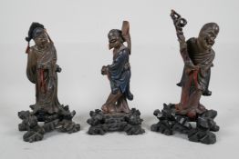 Three Oriental carved and lacquered wood figures of sages, 10" high, A/F