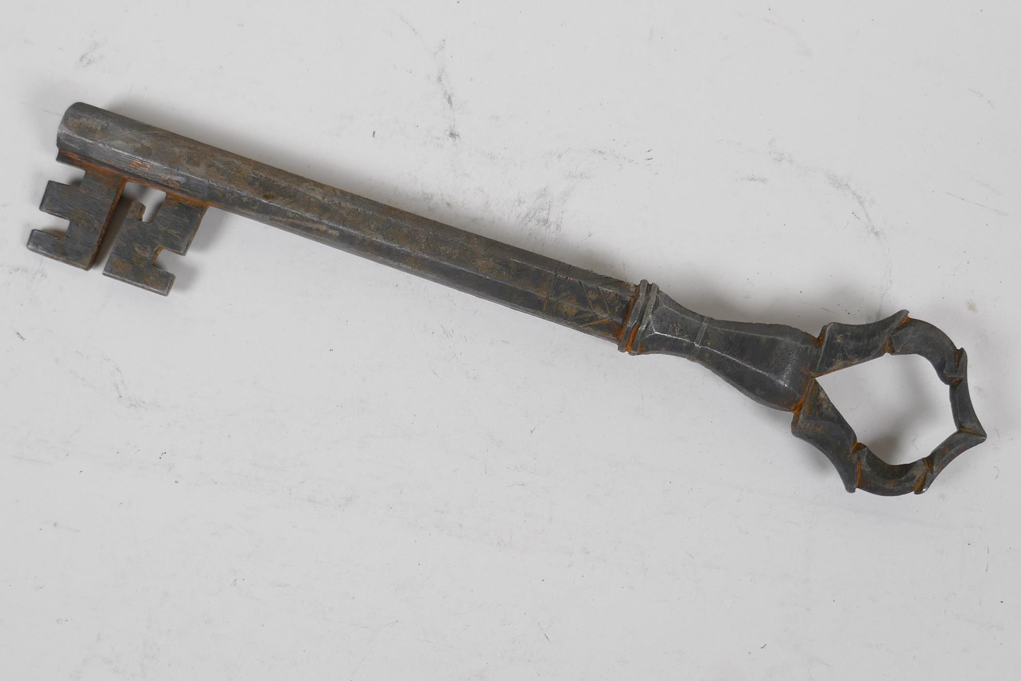 An antique Persian metal key made from a gun barrel, 9" long