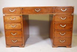 A Starbay hardwood maritime style, nine drawer pedestal desk, with inset campaign style handles