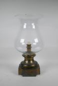 A brass and glass storm lamp, chip to rim, 17½", 9" diameter