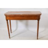A C19th 'D' shaped inlaid mahogany tea table, raised on ring turned tapering supports, 40" x 20" x