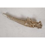 A Chinese white metal cheroot holder cast in the form of a dragon, character mark to base, 4" long