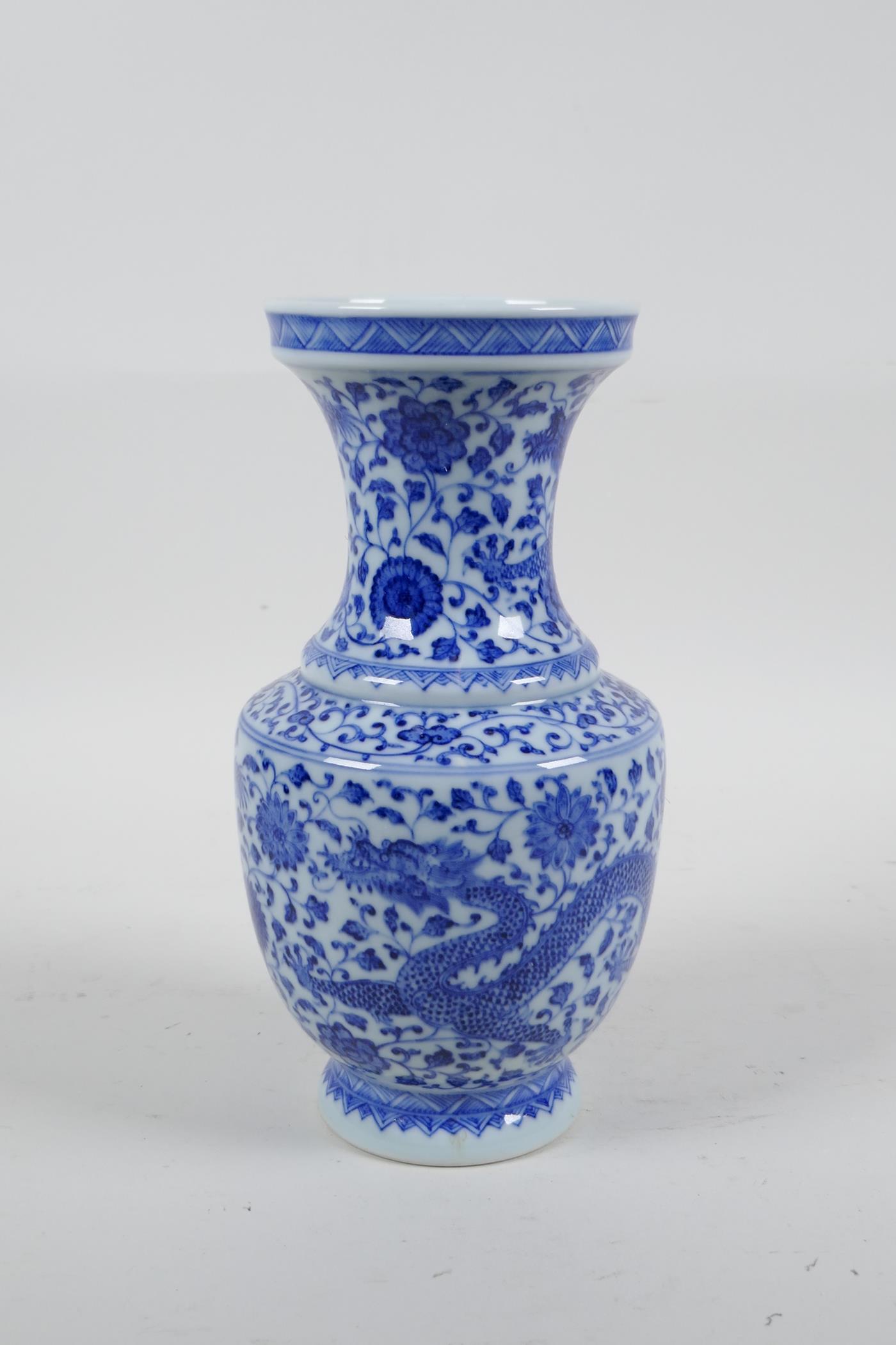 A Chinese blue and white porcelain vase with dragon and lotus flower decoration, seal mark to