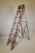 A vintage 'The Hatherly' patent beech stepladder, 80" long in folded form
