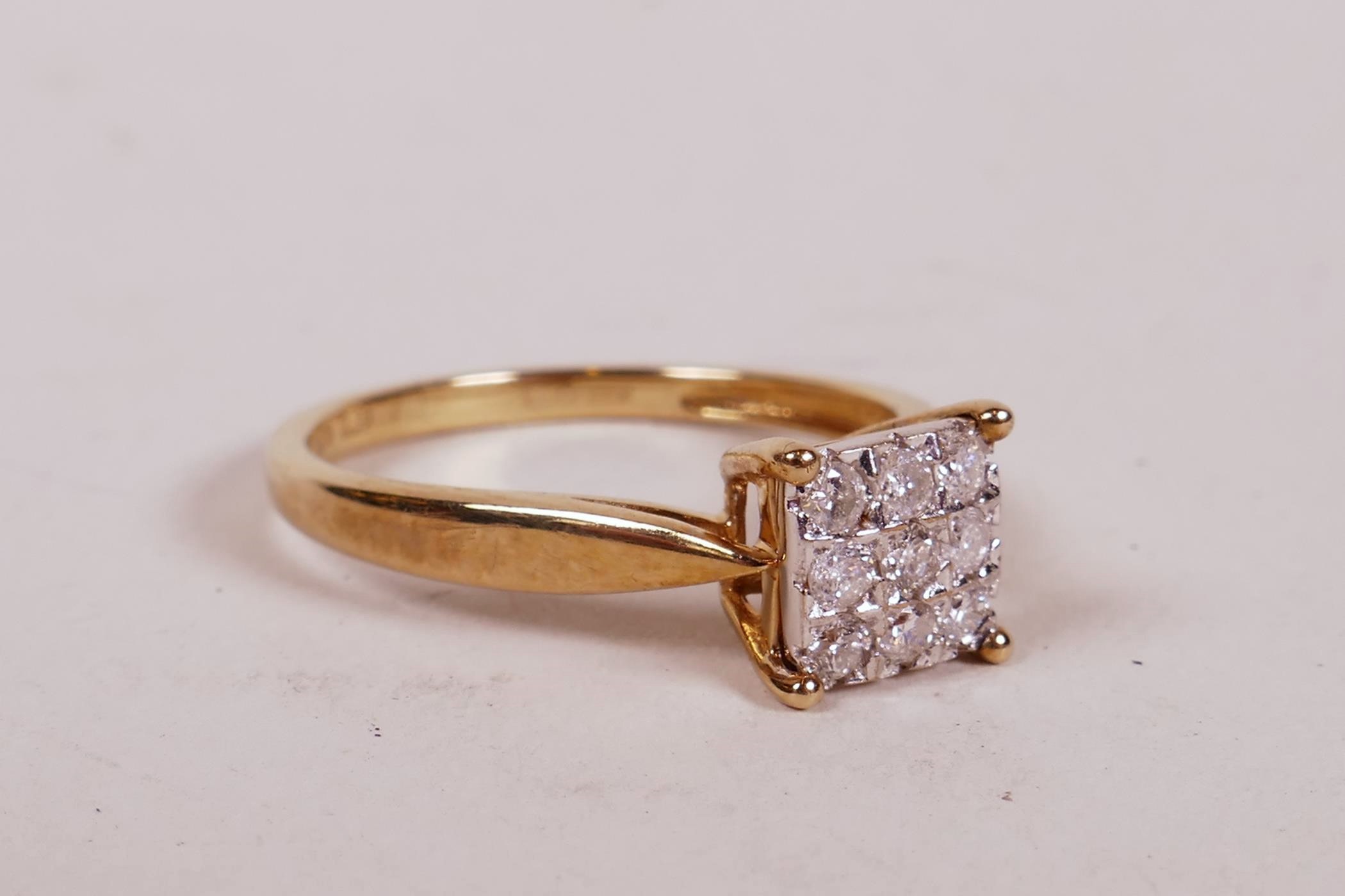 A 9ct yellow gold ring set with a cluster of nine diamonds, 1.6g, size 'L'