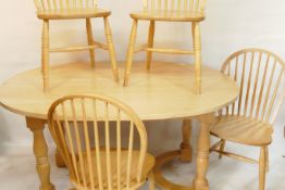 A beechwood dining table with oval top and four hoop back chairs, 41" x 62"