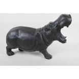 A bronzed metal figure of a hippopotamus, 14" long