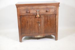 A C19th Dutch mahogany side cabinet with canted ends, pull out slides and lift up top with folding