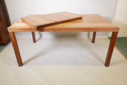 A Danish Dyrlund mid century teak and exotic wood extending dining table with a extra leaf and
