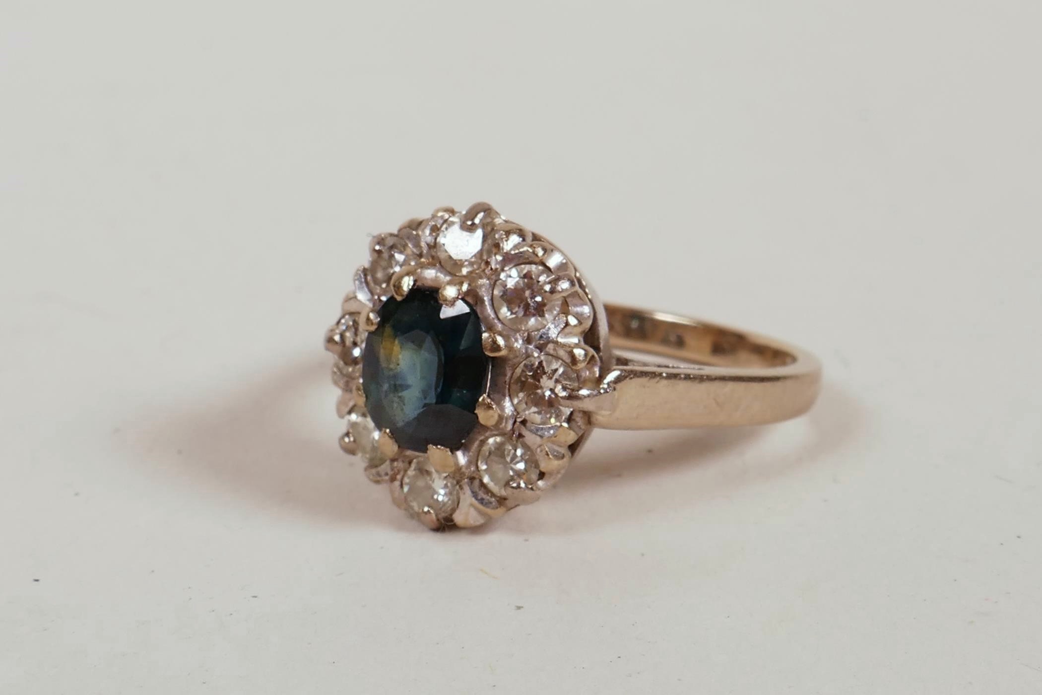 An 18ct white gold dress ring, set with a sapphire and eight diamonds, sapphire approximately 1ct,