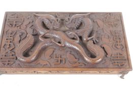 An antique carved wood artist's box, the lid heavily carved with dragons and symbols inside and out,