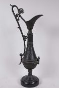 A C19th aesthetic bronze ewer with engraved and applied decoration, mounted on a marble base, 17"