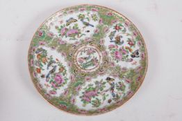 A Canton famille rose porcelain plate decorated with panels of birds, butterflies and flowers, 8"