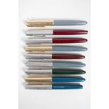 A collection of nine Parker fountain pens all appear to be Parker 51 models, 5" long