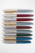 A collection of nine Parker fountain pens all appear to be Parker 51 models, 5" long