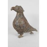 An archaic bronze jar and cover in the form of a bird with chased and engraved decoration, the