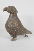 An archaic bronze jar and cover in the form of a bird with chased and engraved decoration, the