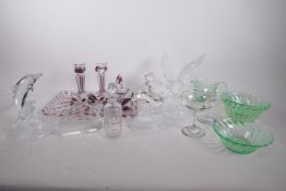 A collection of glassware including dolphin, horse and eagle figures, two colour dressing table