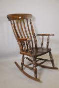 A stained beech Windsor rocking chair, 44" high
