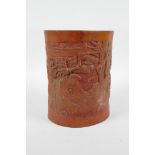 A Chinese carved bamboo brush pot decorated with a sage in a landscape, 6½" high