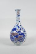 A Chinese blue, white and red porcelain bottle vase with a flared rim, decorated with a kylin with a