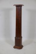 An early C20th mahogany torchere formed as four conjoined pillars, 44" high