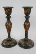 A pair of Kashmiri papier mache candlesticks painted with flowers, 9½" high