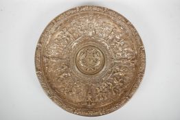 A gilt bronze charger with repousse putti decoration, the centre decorated with a heraldic crest