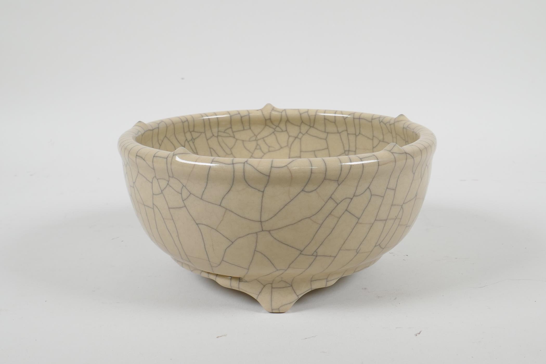 A Chinese Song style crackle glazed porcelain bowl on tripod feet, 6" diameter