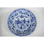 A Chinese blue and white porcelain charger decorated with travellers on horseback, 18½" diameter,