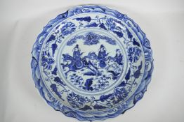 A Chinese blue and white porcelain charger decorated with travellers on horseback, 18½" diameter,