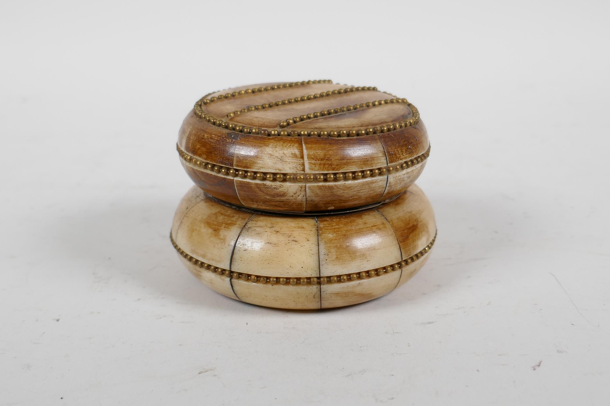 A sectional bone box and cover with brass beaded details, 3" diameter