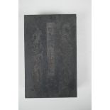 A Chinese wood and material bound book containing white jade tablets with engraved and gilt