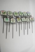 A set of twelve painted cast iron herb garden plant markers, 2¾" x 3"