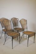A set of four wrought metal conservatory chairs, with bamboo seats and backs