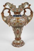 A German Art Nouveau porcelain two handled vase embossed and painted with stylised flowers by