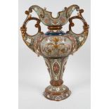 A German Art Nouveau porcelain two handled vase embossed and painted with stylised flowers by