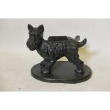 A vintage painted cast iron bootscraper in the form of an Angus terrier cocking his leg, 16" x 14"
